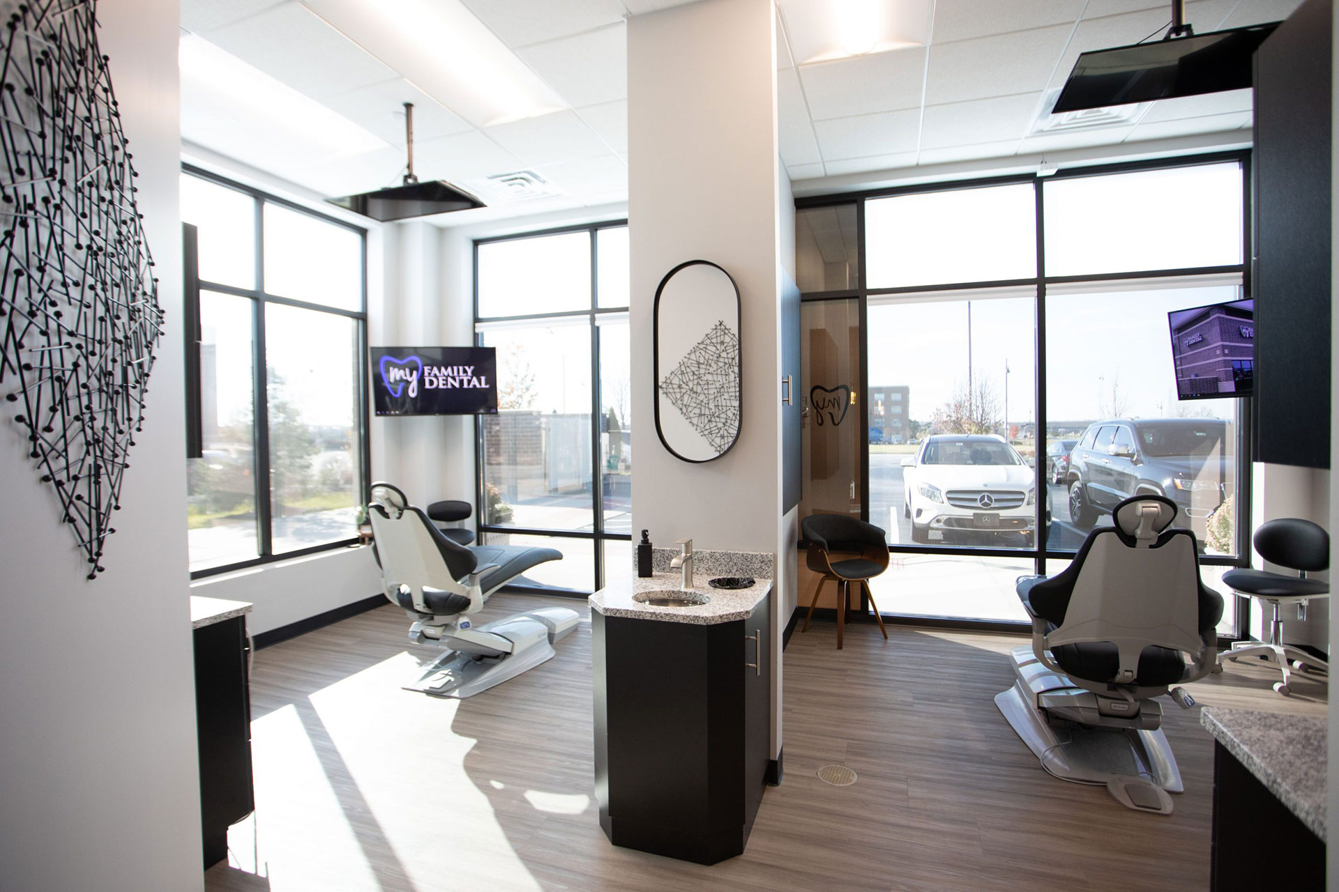 The image depicts an interior space resembling a modern hair salon with styling stations, a reception area, and a large window allowing natural light into the room.